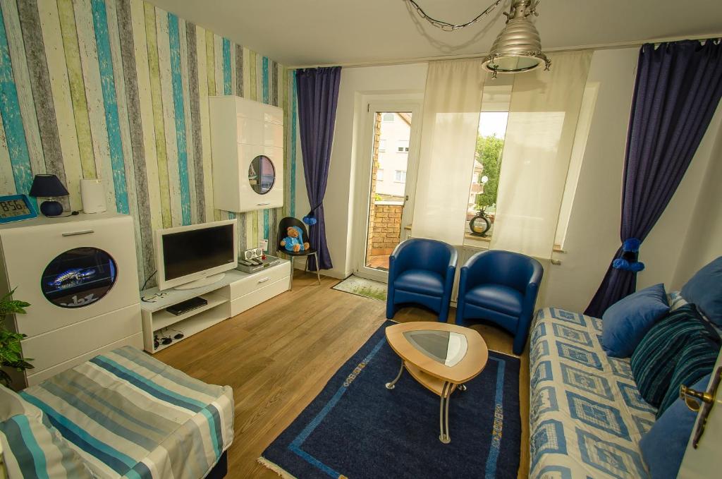 ein Wohnzimmer mit einem Bett und einem TV in der Unterkunft Ferienwohnung Cologne in Frechen