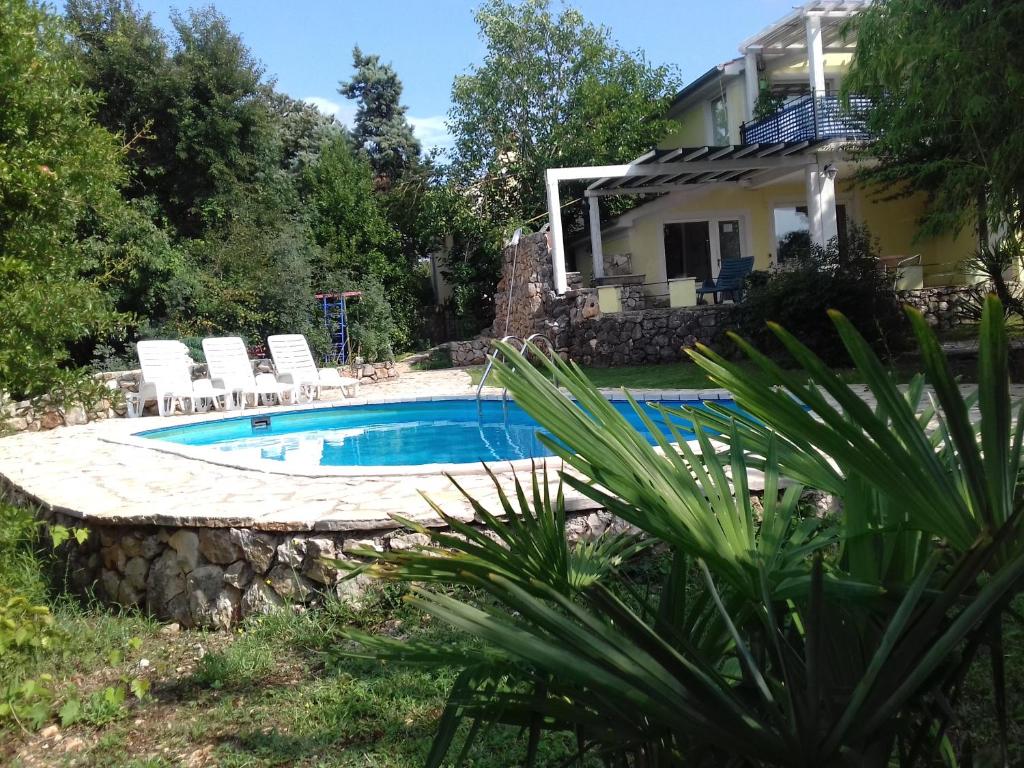 a swimming pool in front of a house at Lavanda in Gabonjin