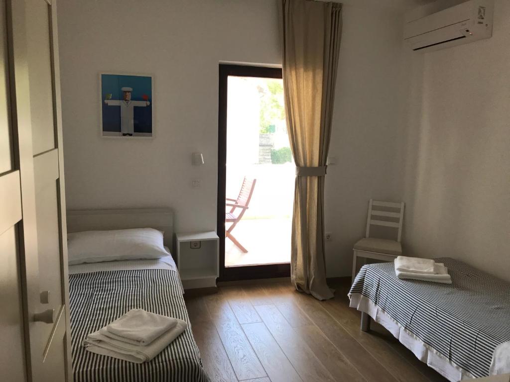 Postel nebo postele na pokoji v ubytování Apartments Vala
