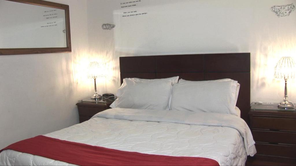 Postel nebo postele na pokoji v ubytování Hotel Apartasuite Normandia