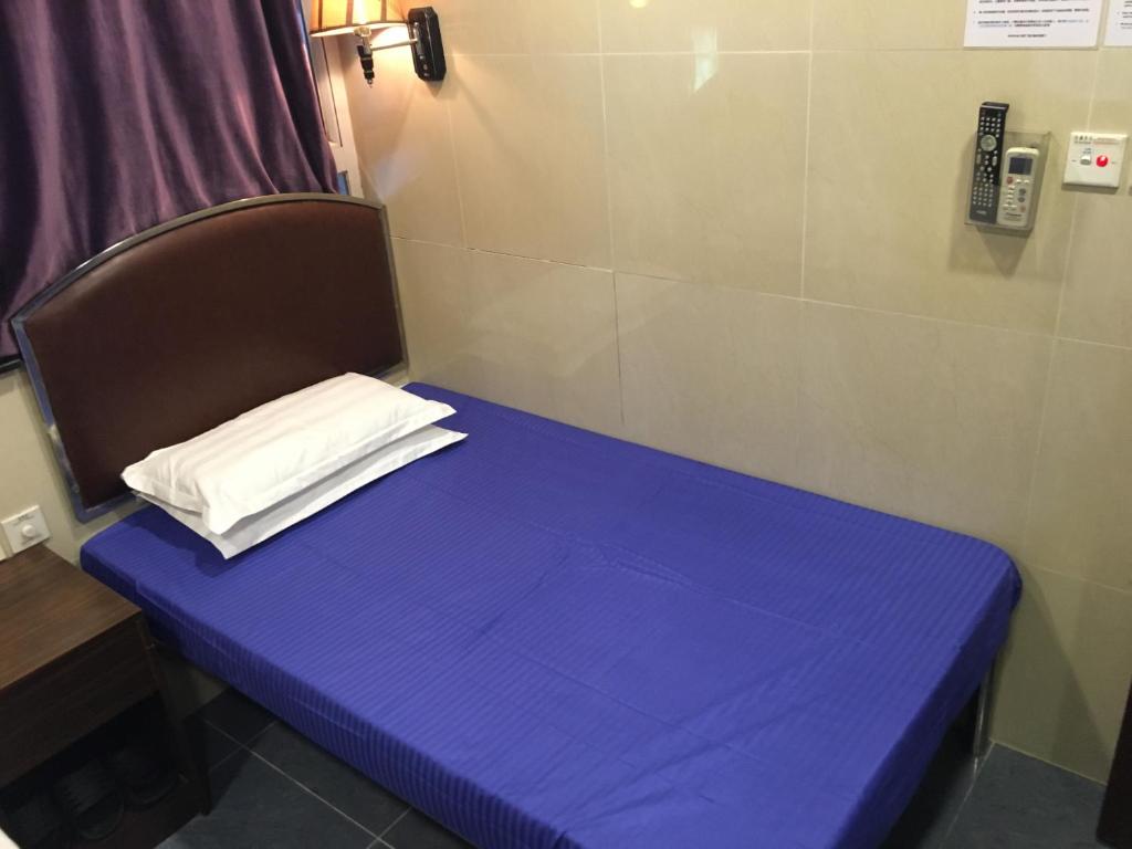 Postel nebo postele na pokoji v ubytování Kowloon YOUTH Village Tsim Sha Tsui 九龙青年公寓