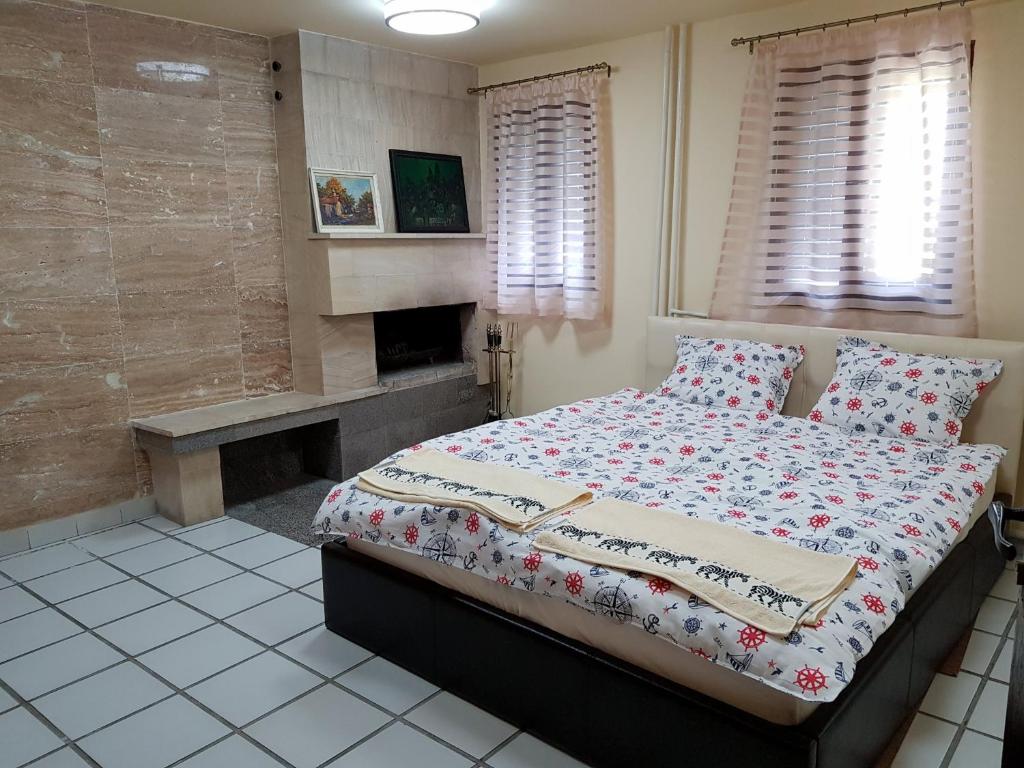 a bedroom with a bed and a fireplace at Holiday Home Arbanasi in Arbanasi