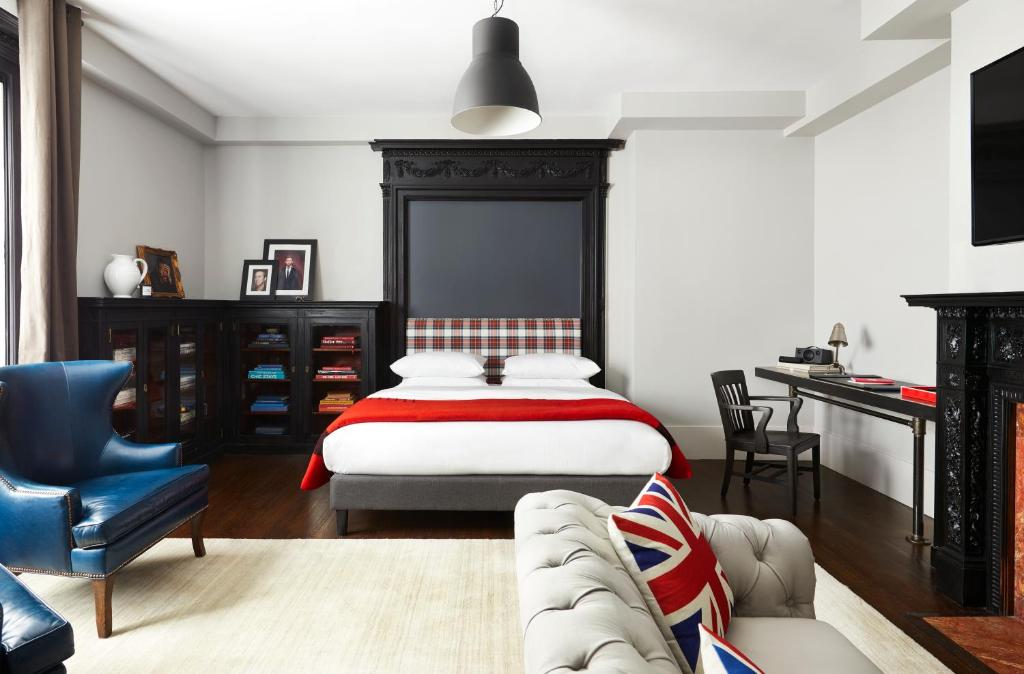 a bedroom with a bed and a couch and a desk at The George in Montclair
