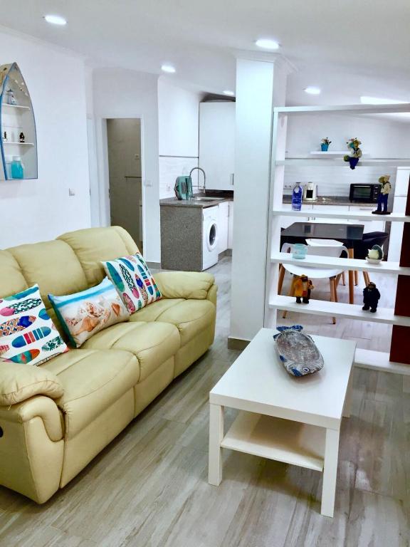a living room with a couch and a table at Flipflops Apartment in Nazaré