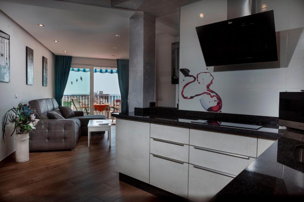 a living room with a flat screen tv on the wall at TuttiFruttiaApt in Nerja