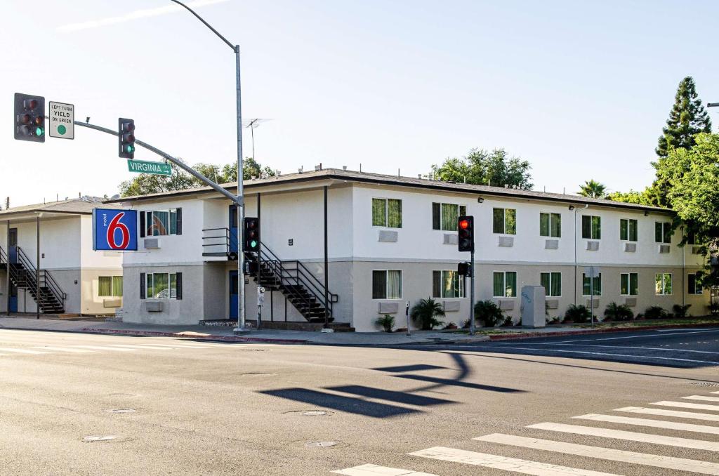 un bâtiment blanc dans une rue avec un feu de circulation dans l'établissement Motel 6-Modesto, CA - Downtown, à Modesto