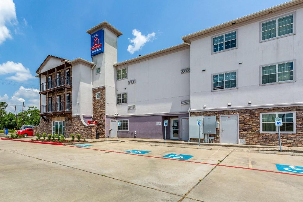 a building with a krispy kreme sign on it at Studio 6-Orange, TX in Orange