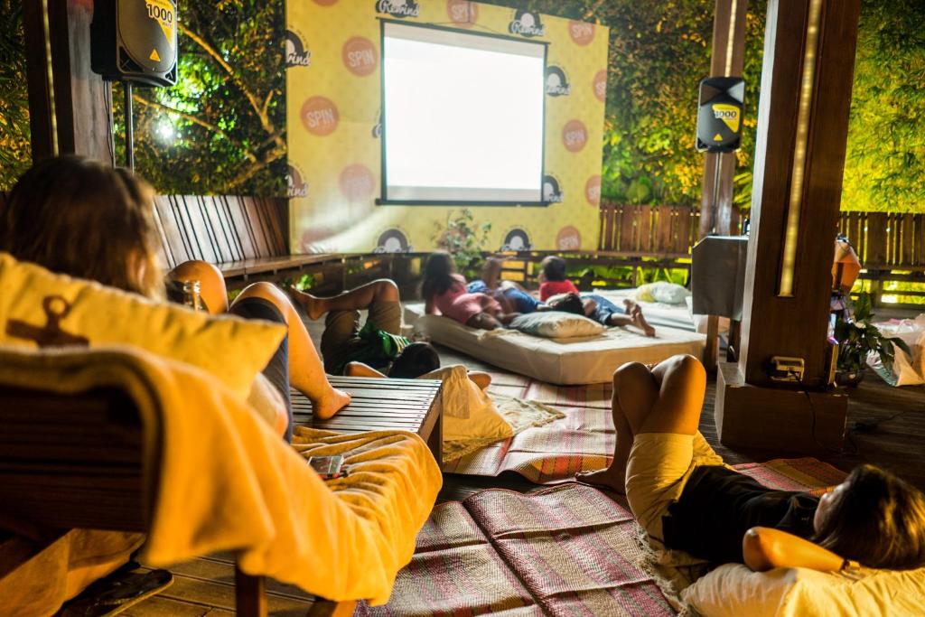 a group of people laying on beds in a room at Spin Designer Hostel - El Nido in El Nido