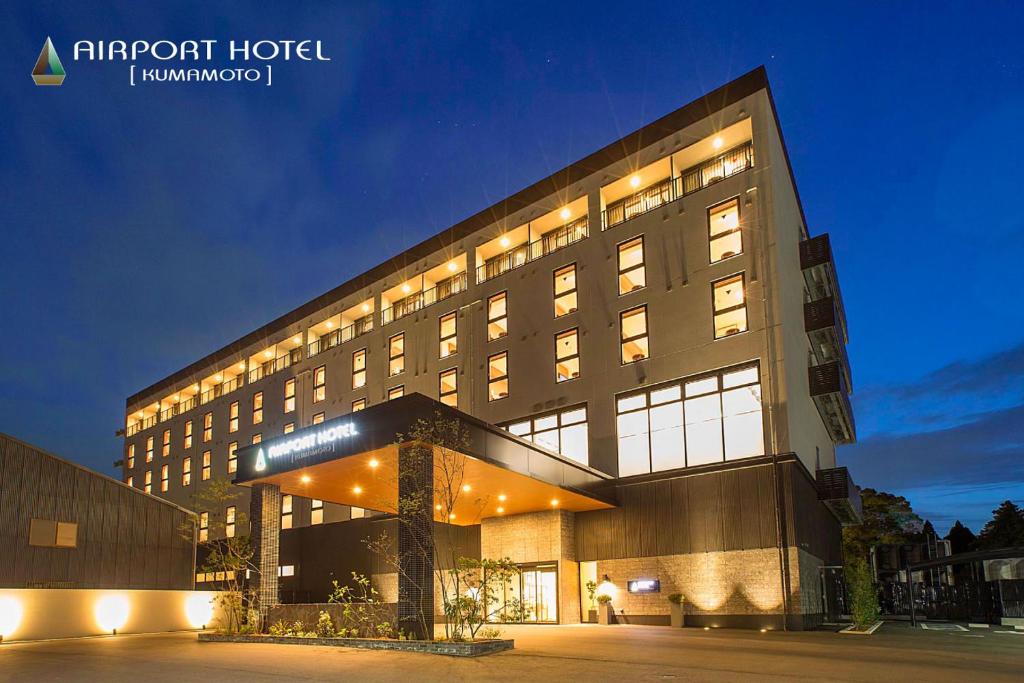 a large building with lights in front of it at Airport Hotel Kumamoto in Ozu