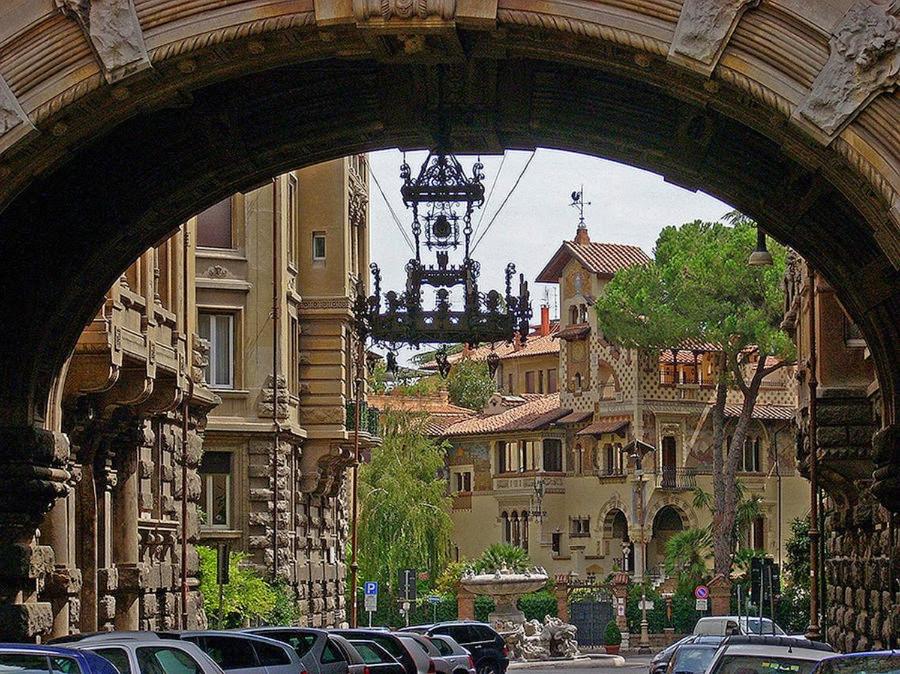 an archway in a city with cars parked on a street at Hotel Coppede' in Rome