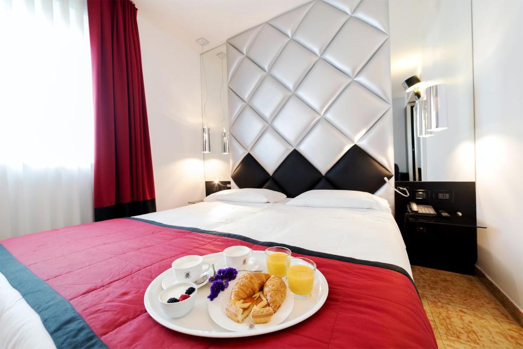 Postel nebo postele na pokoji v ubytování Corte Ongaro Hotel
