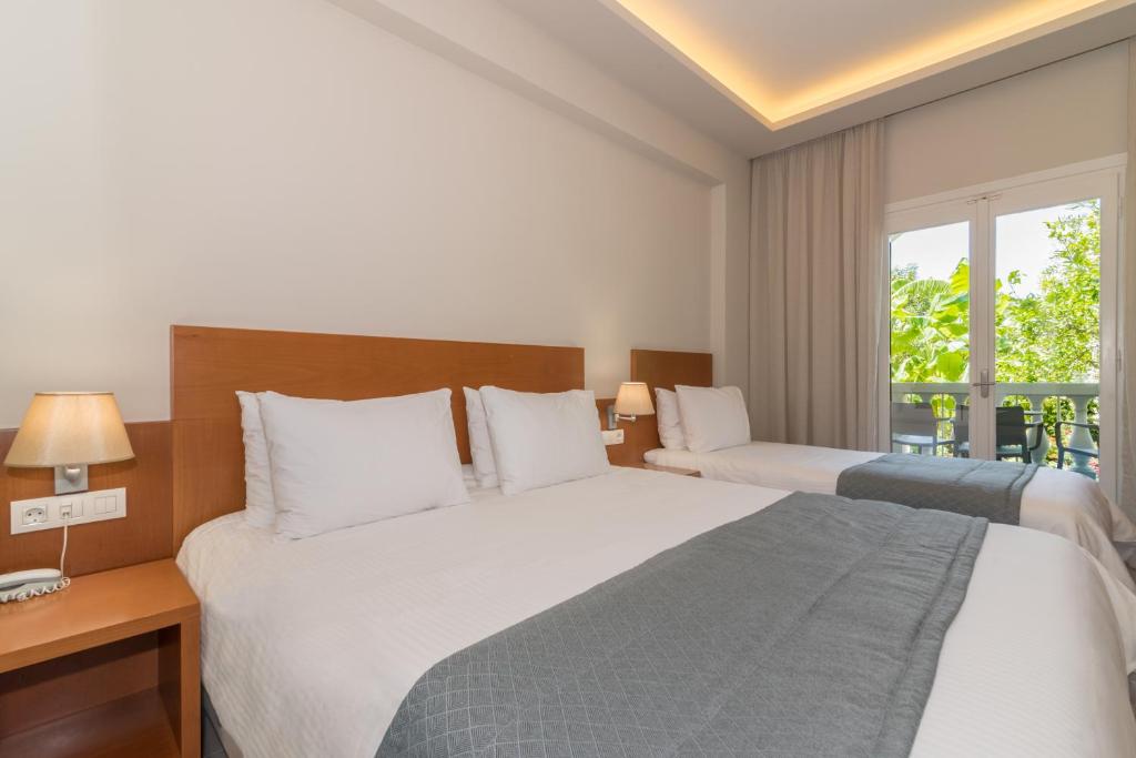 Postel nebo postele na pokoji v ubytování Hotel Palmyra