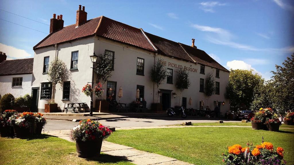 a large white building with flowers in front of it at The Pickled Parson of Sedgefield in Sedgefield