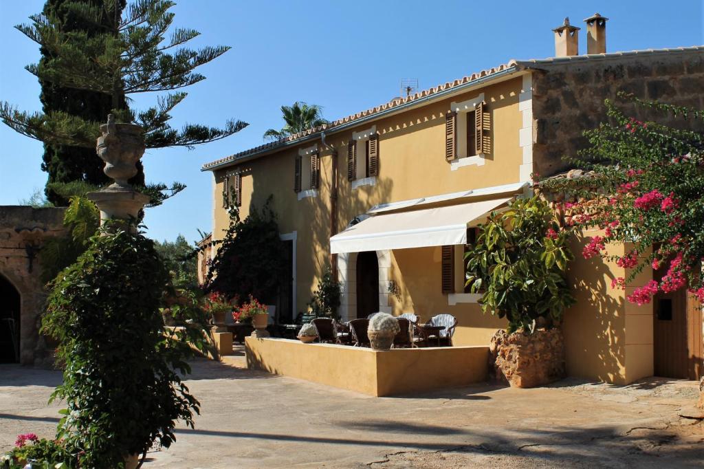 a courtyard of a building with a fountain and flowers at Agroturismo Finca Son Pieras in Llucmajor