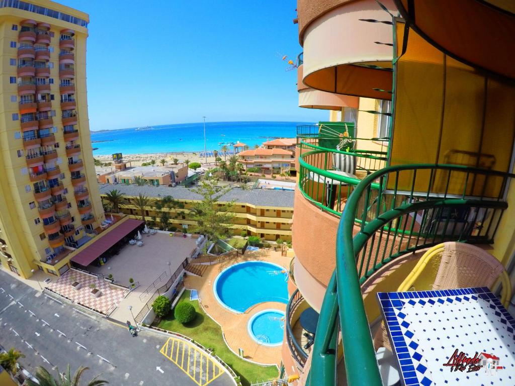 a view from a balcony of a resort with a pool at Torres del Sol in Playa de las Americas