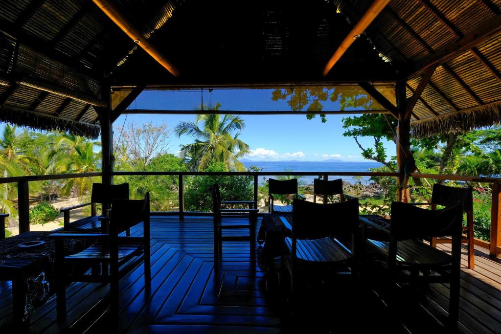 a restaurant with a view of the ocean at Coco Komba Lodge in Nosy Komba
