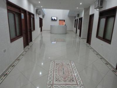 un pasillo de un edificio con una alfombra en el suelo en Hotel Los Paisas, en Mitú