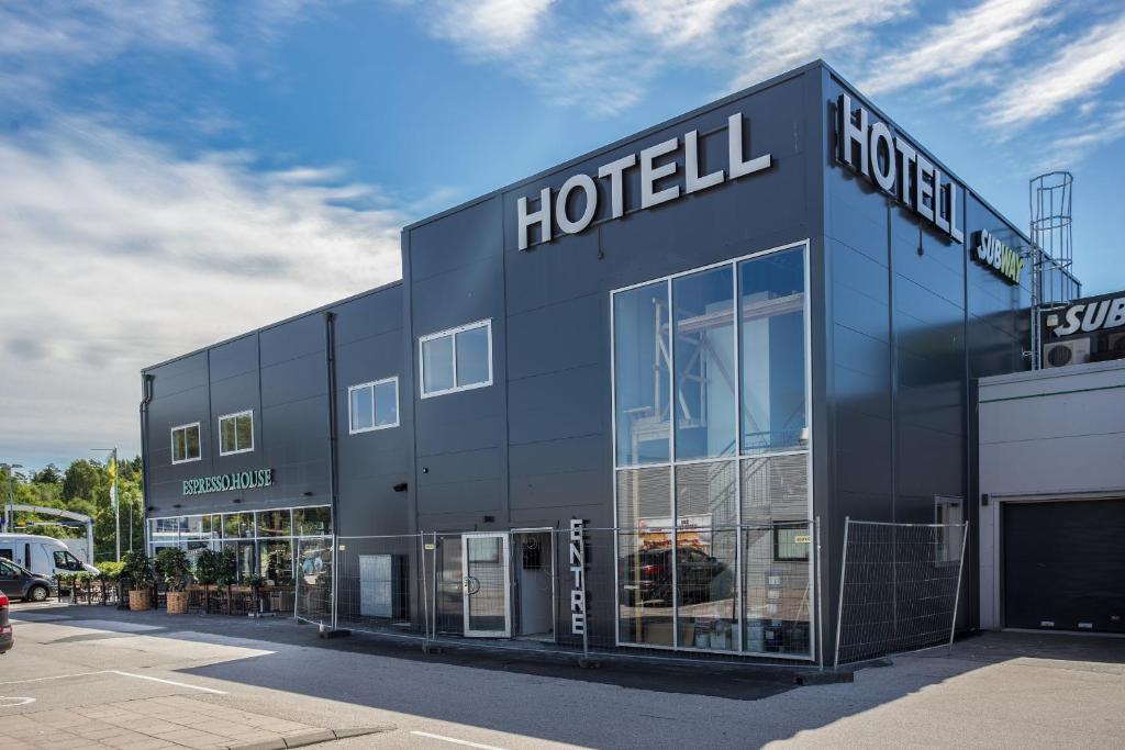 a black building with the words hotel on it at Hotel Spekeröd in Stenungsund