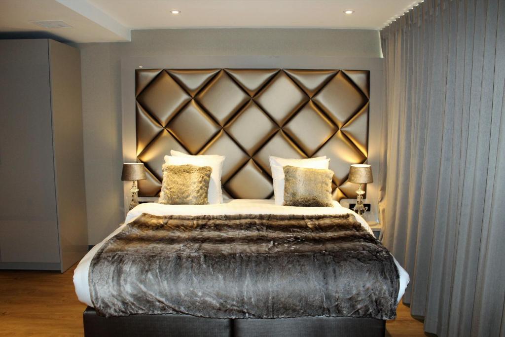 a bedroom with a large bed and a large window at Dream Hotel Amsterdam in Amsterdam