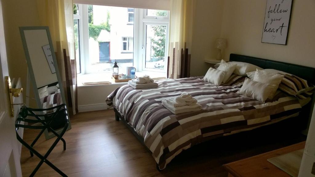 a bedroom with a large bed with towels on it at The Townhouse in Elphin