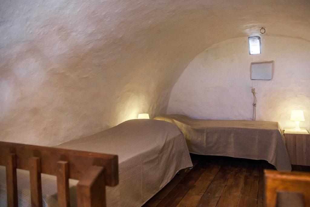 Postel nebo postele na pokoji v ubytování Trulli e Masseria Ianella