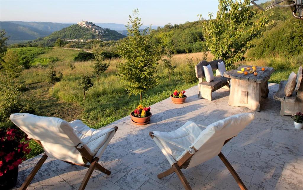 a patio with two chairs and a table with a view at Casa Rodeli in Motovun