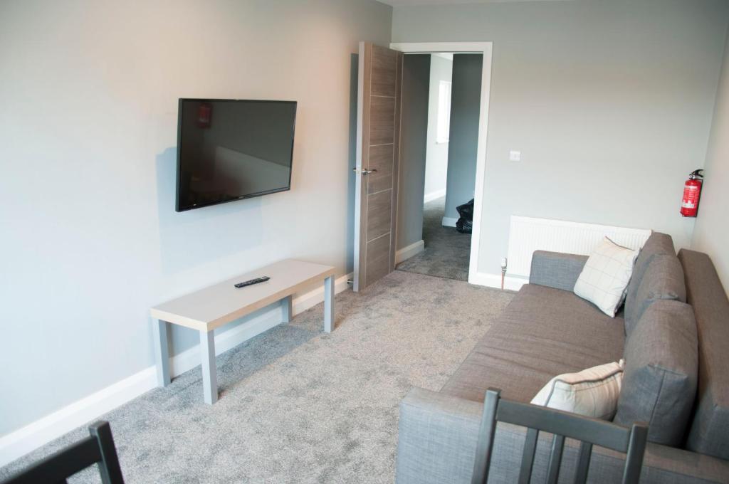 
A television and/or entertainment center at The Square Guest Apartment
