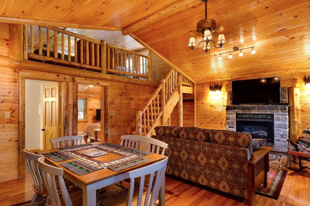 a living room filled with furniture and a fireplace at Cobble Mountain Lodge in Lake Placid