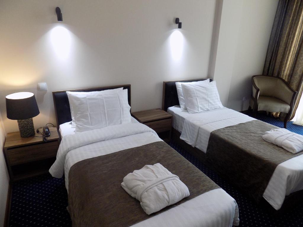 Postel nebo postele na pokoji v ubytování Garden Palace