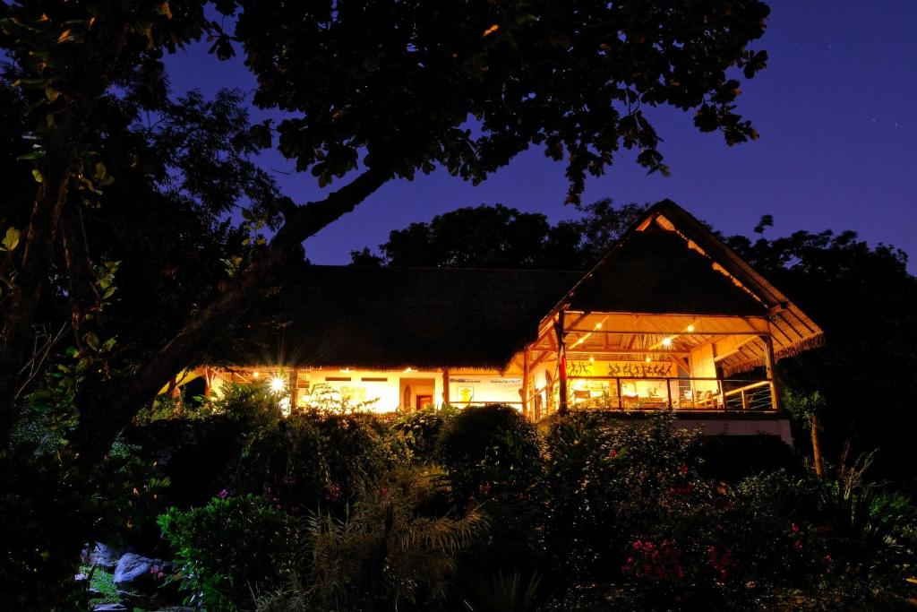 a house lit up at night at Coco Komba Lodge in Nosy Komba