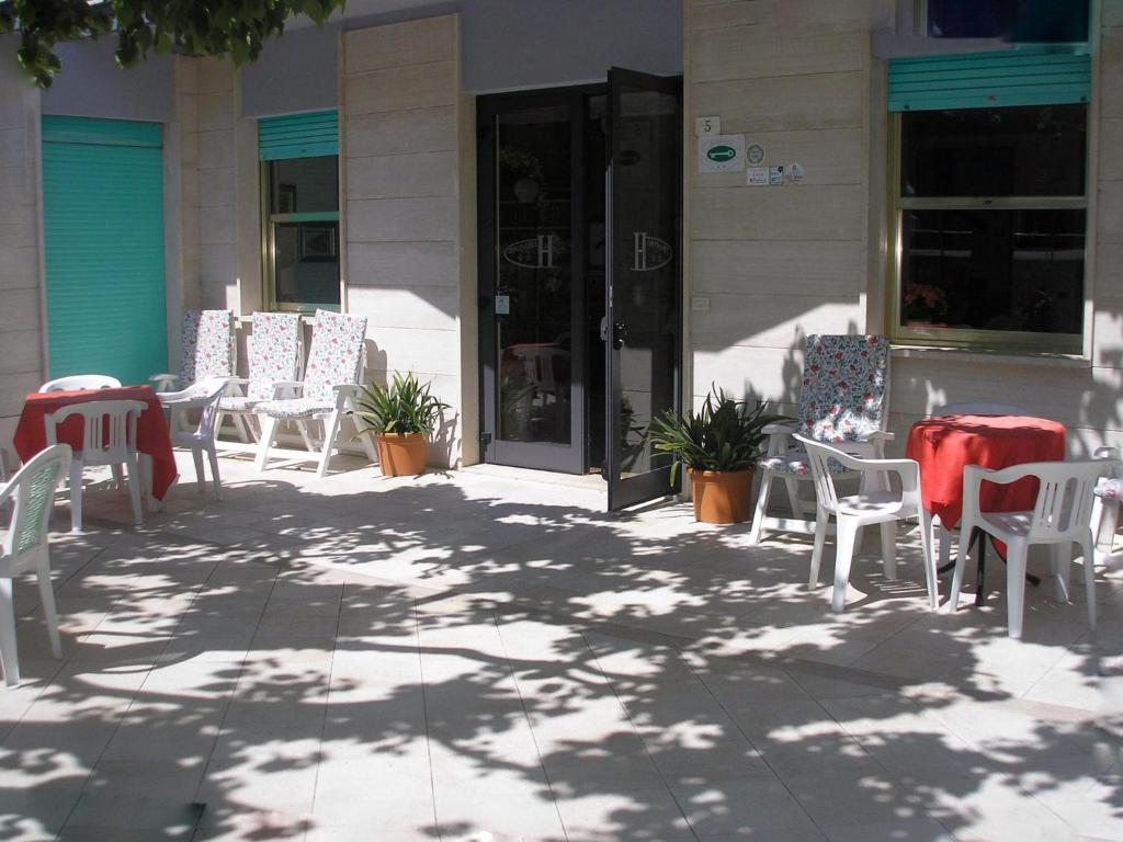 a group of chairs and tables on a patio at Albergo Villa Dionori in Chianciano Terme