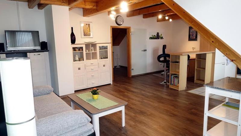 a living room with a couch and a table at Haus Fliegerhorst in Königschaffhausen