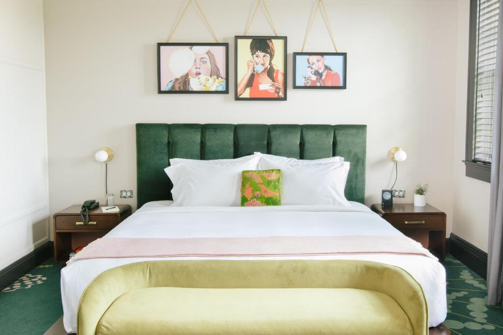 a bedroom with a large bed with a green headboard at Hotel Clermont Atlanta, by Oliver in Atlanta