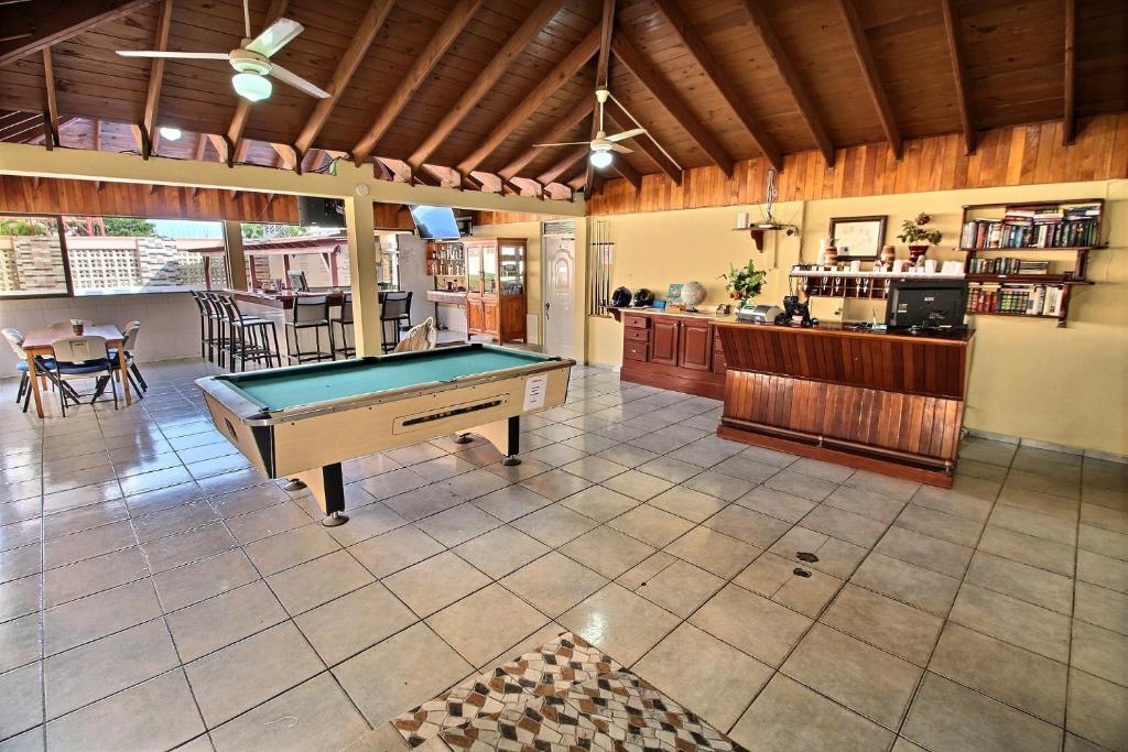 a large room with a pool table in it at Hotel Garant & Suites in Boca Chica