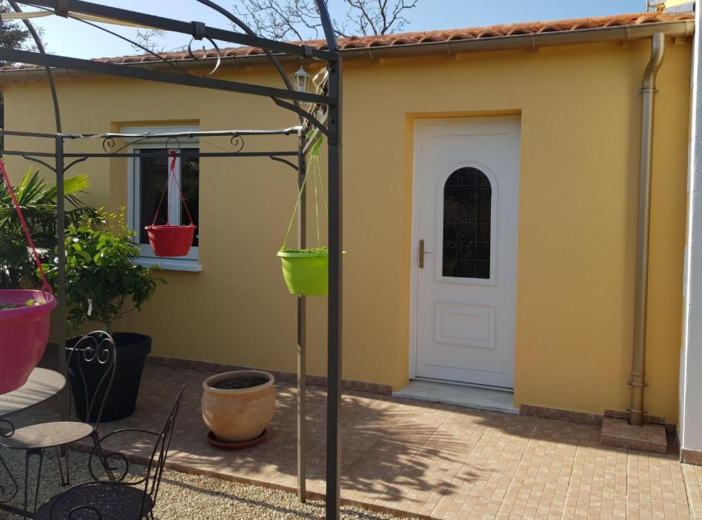 a house with a white door and a patio at 19 Rue du Cadran in Montmorillon