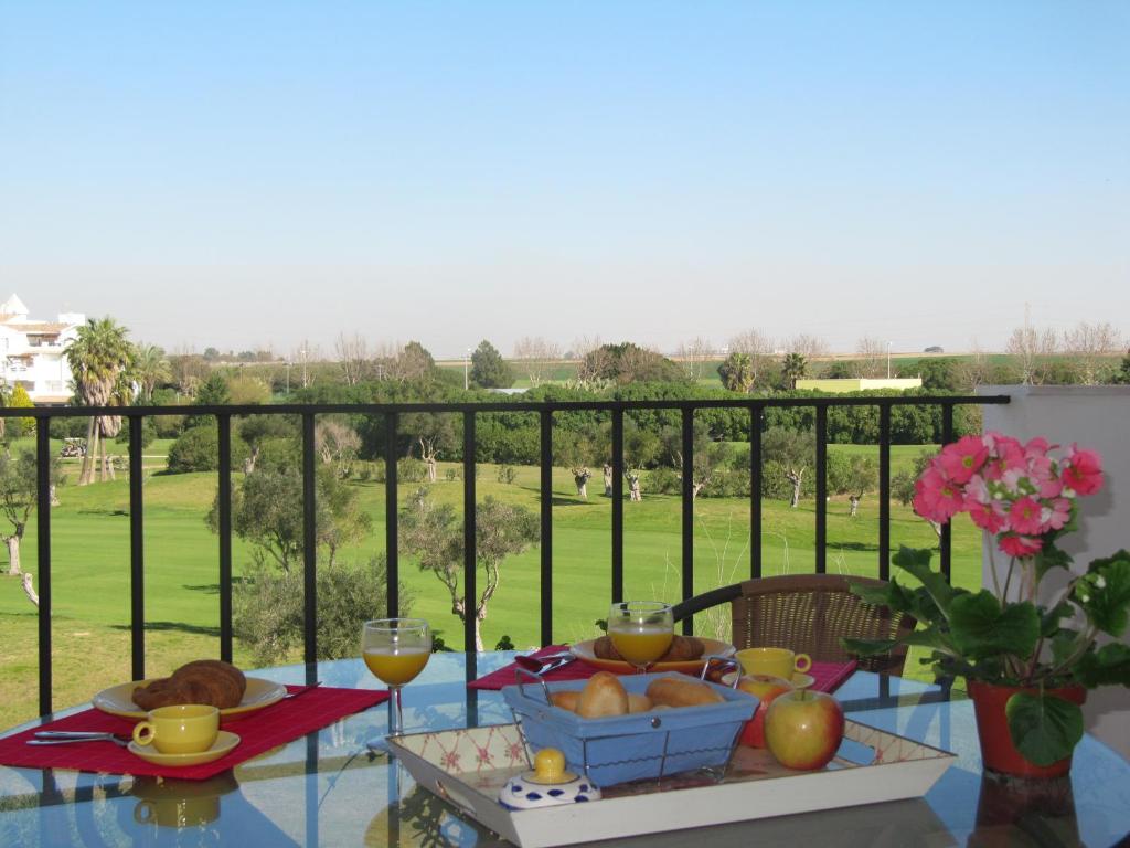 a table with a bowl of bread and wine glasses at Life Apartments Costa Ballena in Costa Ballena