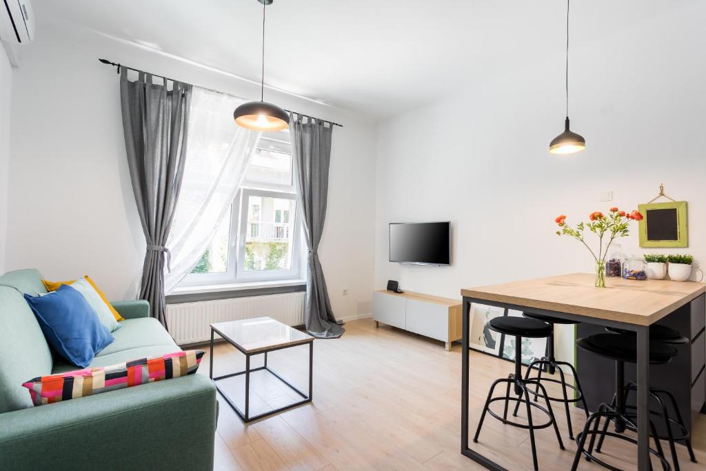 a living room with a couch and a table at Go2Zagreb Chick Apartment in Zagreb