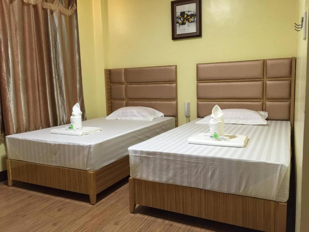 Postel nebo postele na pokoji v ubytování Meaco Royal Hotel - Plaridel