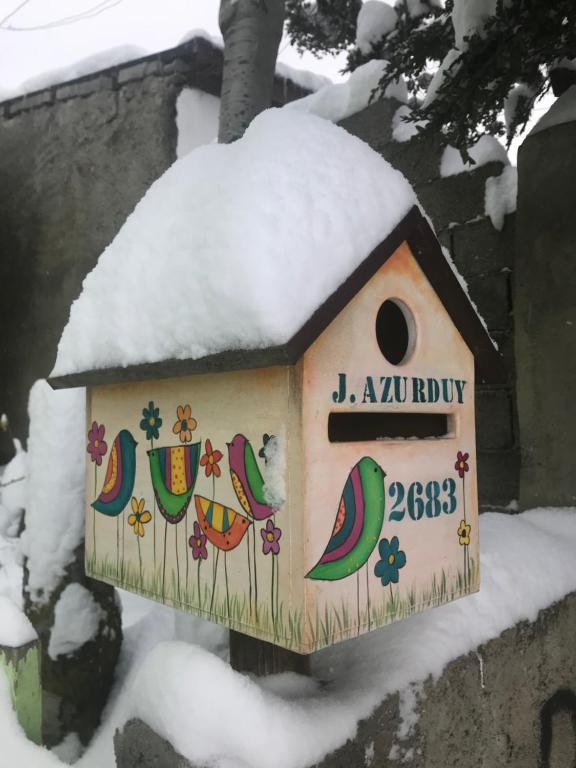 a bird house with snow on top of it at chula"s house in Ushuaia