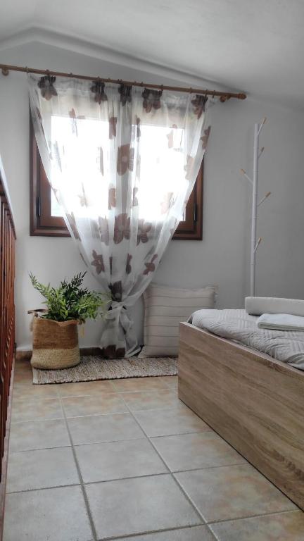a bedroom with a bed and a window at Villa Maraki in Agia Paraskevi