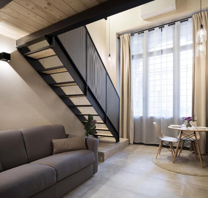 a living room with a couch and a staircase at Borgo De Chiari in Bologna
