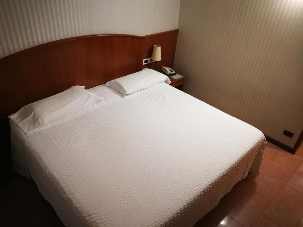 Postel nebo postele na pokoji v ubytování Hotel Willy