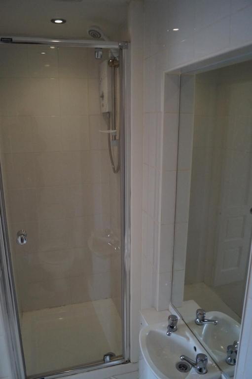 a bathroom with a shower and a sink at 133 A Park Road in Manchester