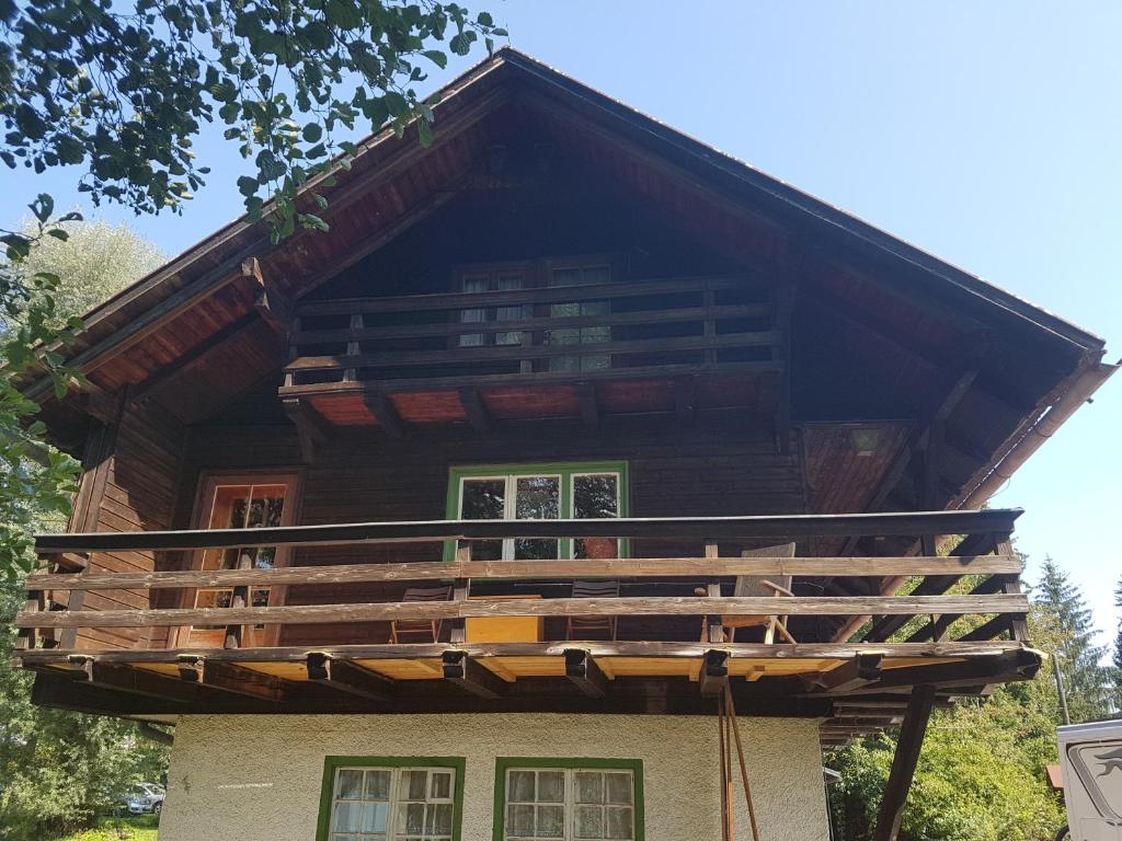 a house with a balcony on top of it at Chalet am See in Keutschach am See