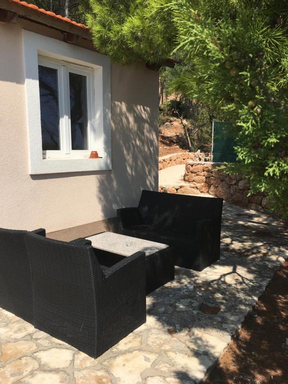 a couch and a table in front of a window at Beach house Korina in Sveta Nedelja