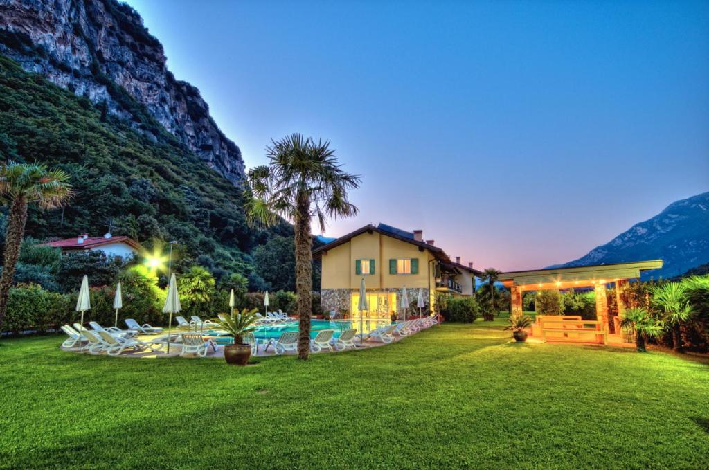 una casa con un patio con sillas y una piscina en Residence Verdeblu en Arco