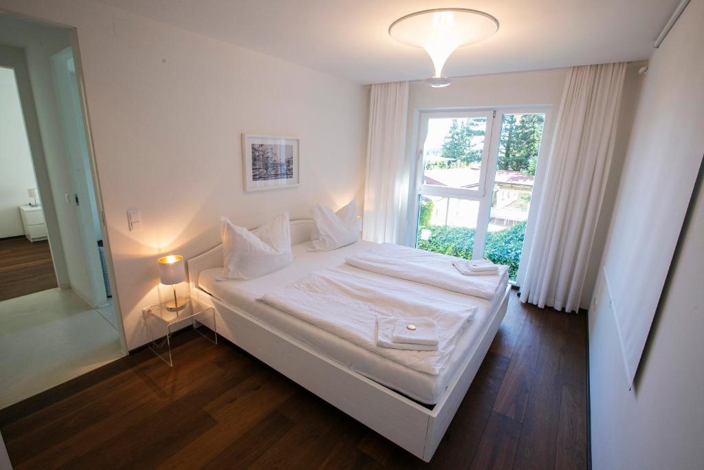 ウィーンにあるLUXURY APARTMENTS "GARDEN OF EDEN"の窓付きの客室の白いベッド1台