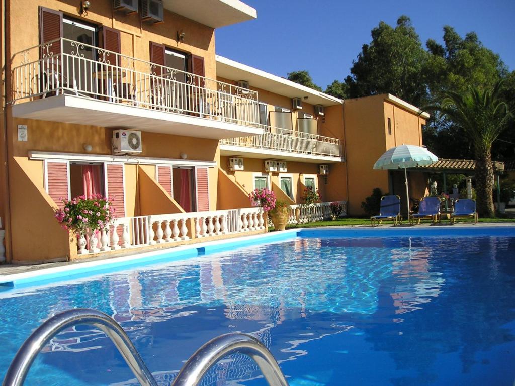 a large swimming pool in front of a building at River Studios & Apartments in Mesongi