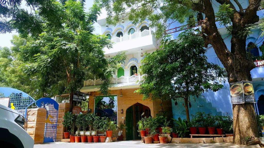 a building with a tree in front of it at Durag Niwas Guest House in Jodhpur