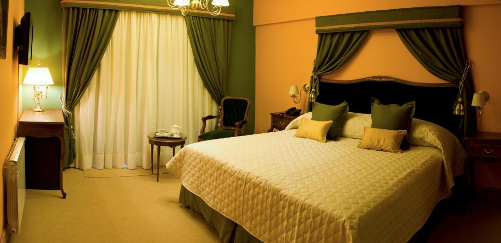 Säng eller sängar i ett rum på Hosteria Patagon